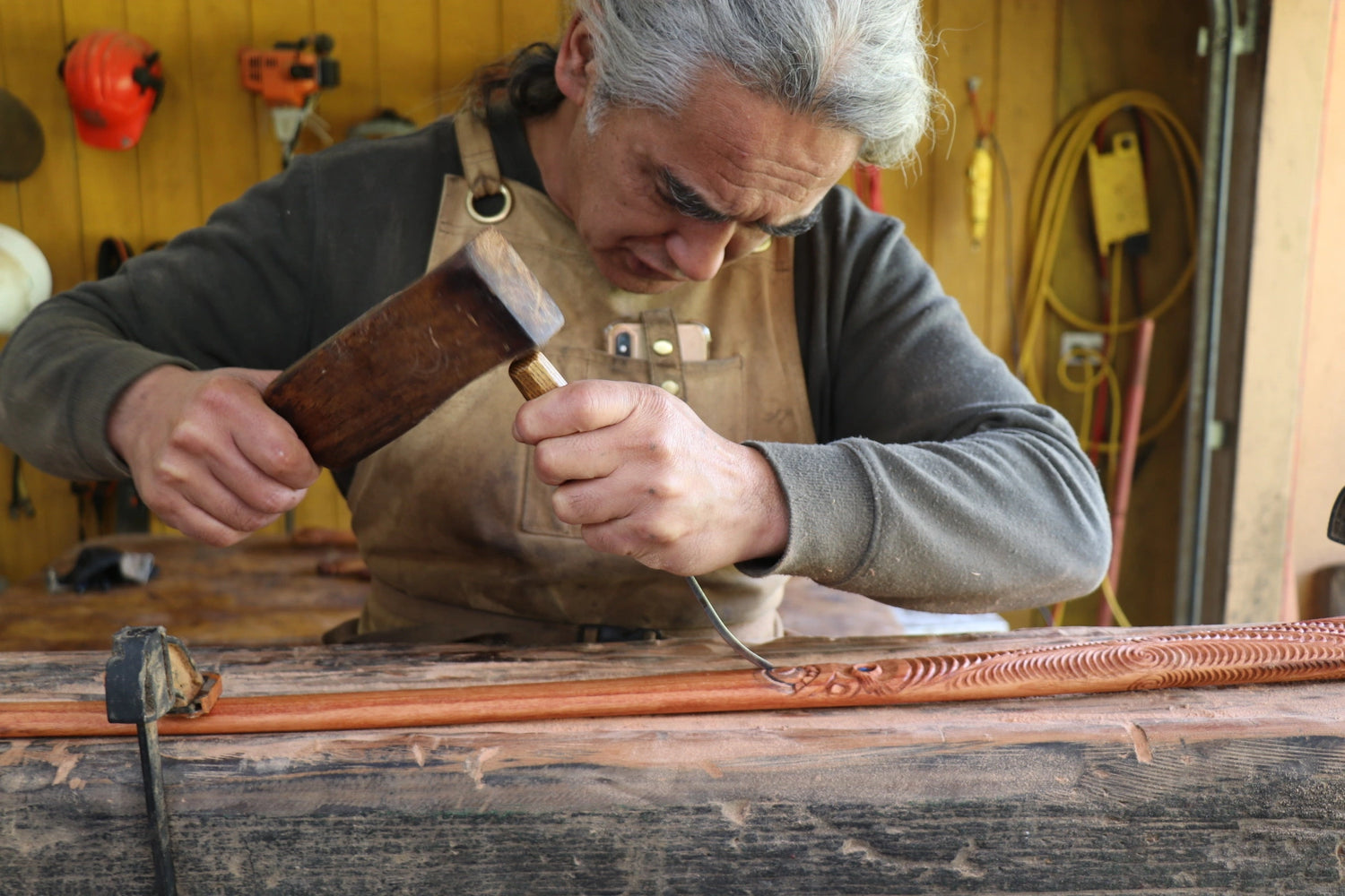 Mark carving in his workshop